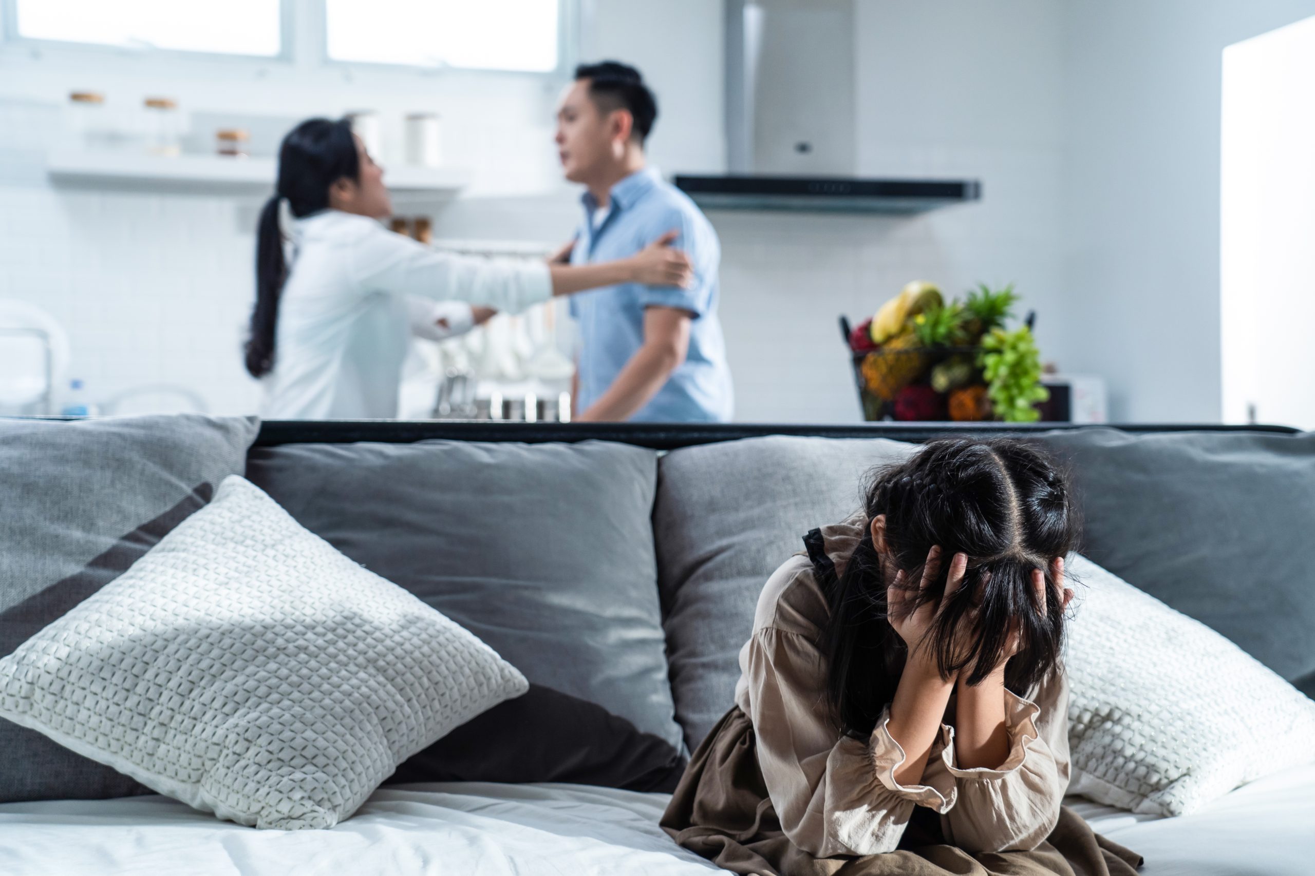 asian-girl-kid-sitting-and-crying-on-bed-while-par-2023-11-27-05-05-26-utc